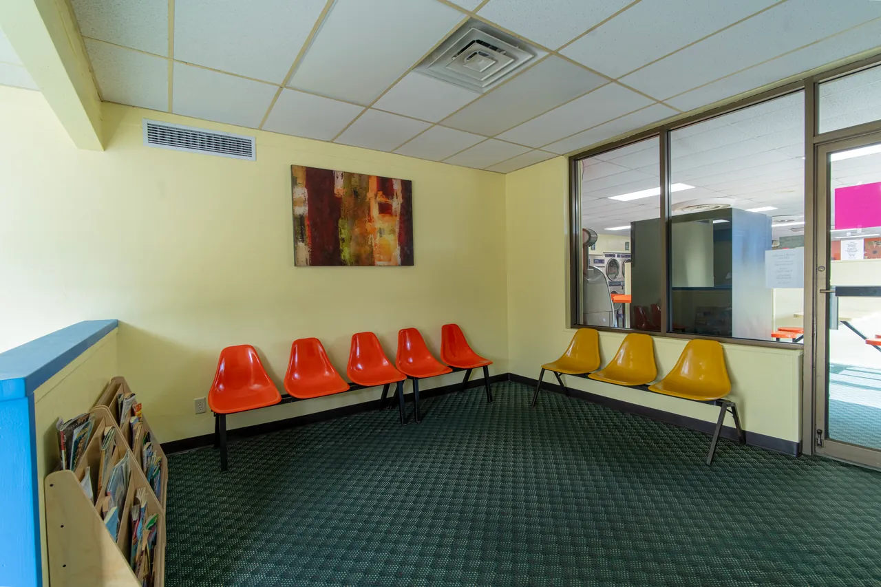 Red and yellow customer seating inside Rockford Washer