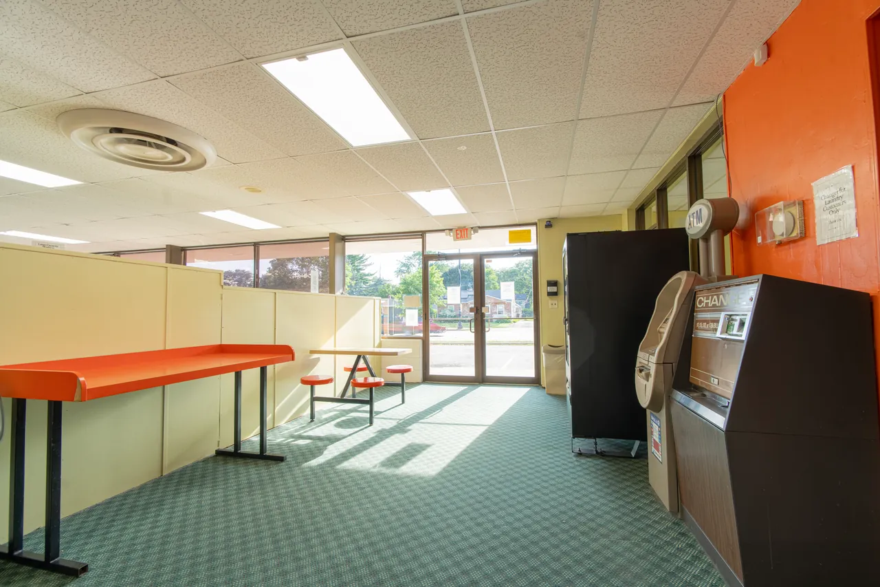 Orange folding tables near the entrance and vending machines